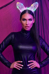White illuminated filigree cat ears headband worn by a model, with glowing pink, blue and yellow LED lights against a purple backdrop